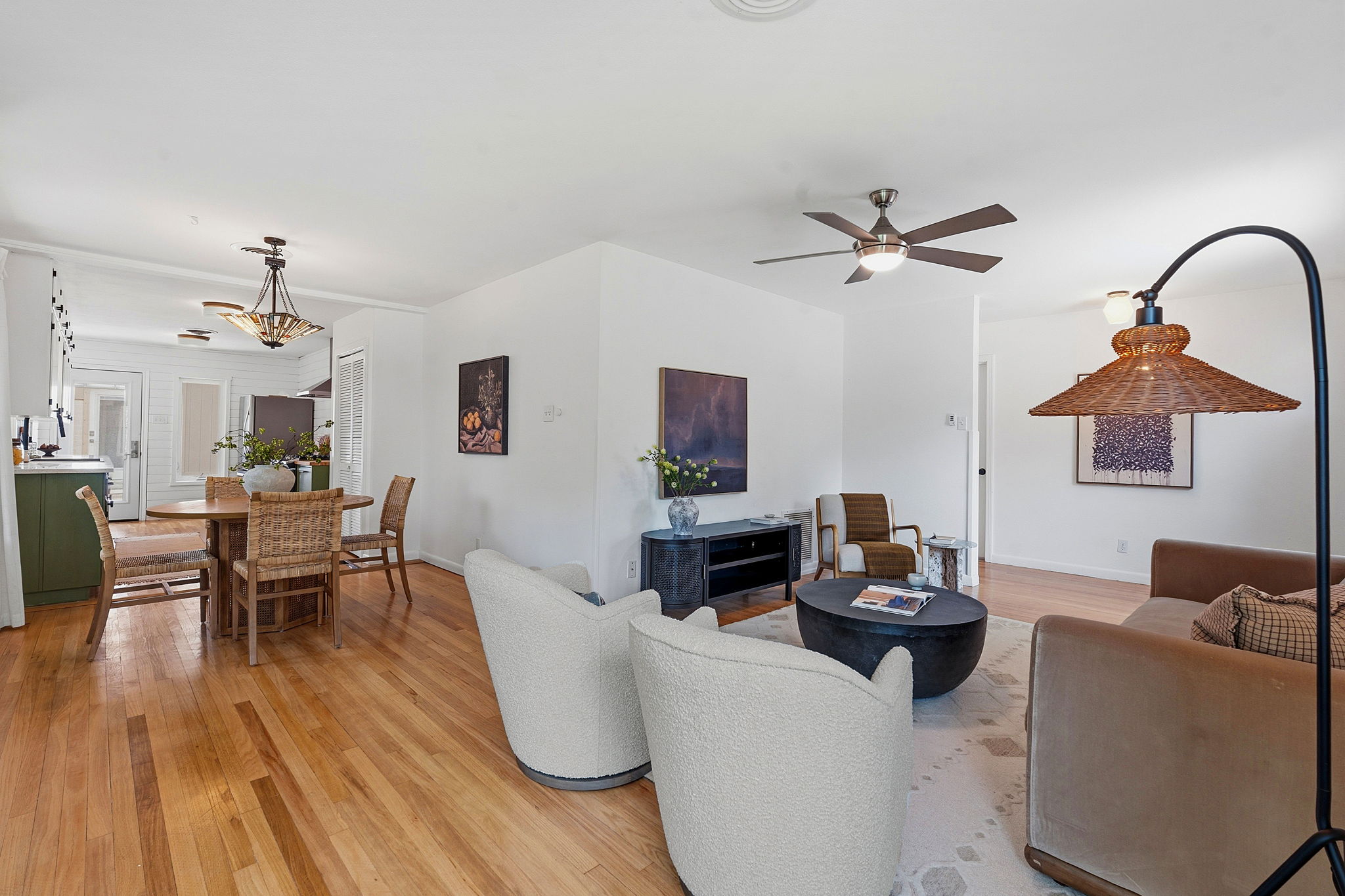 900 Stark Street Austin, TX 78756 - Photo 5 of 25 Hardwood floors stretch across this inviting living and dining space, illuminated by overhead lighting.