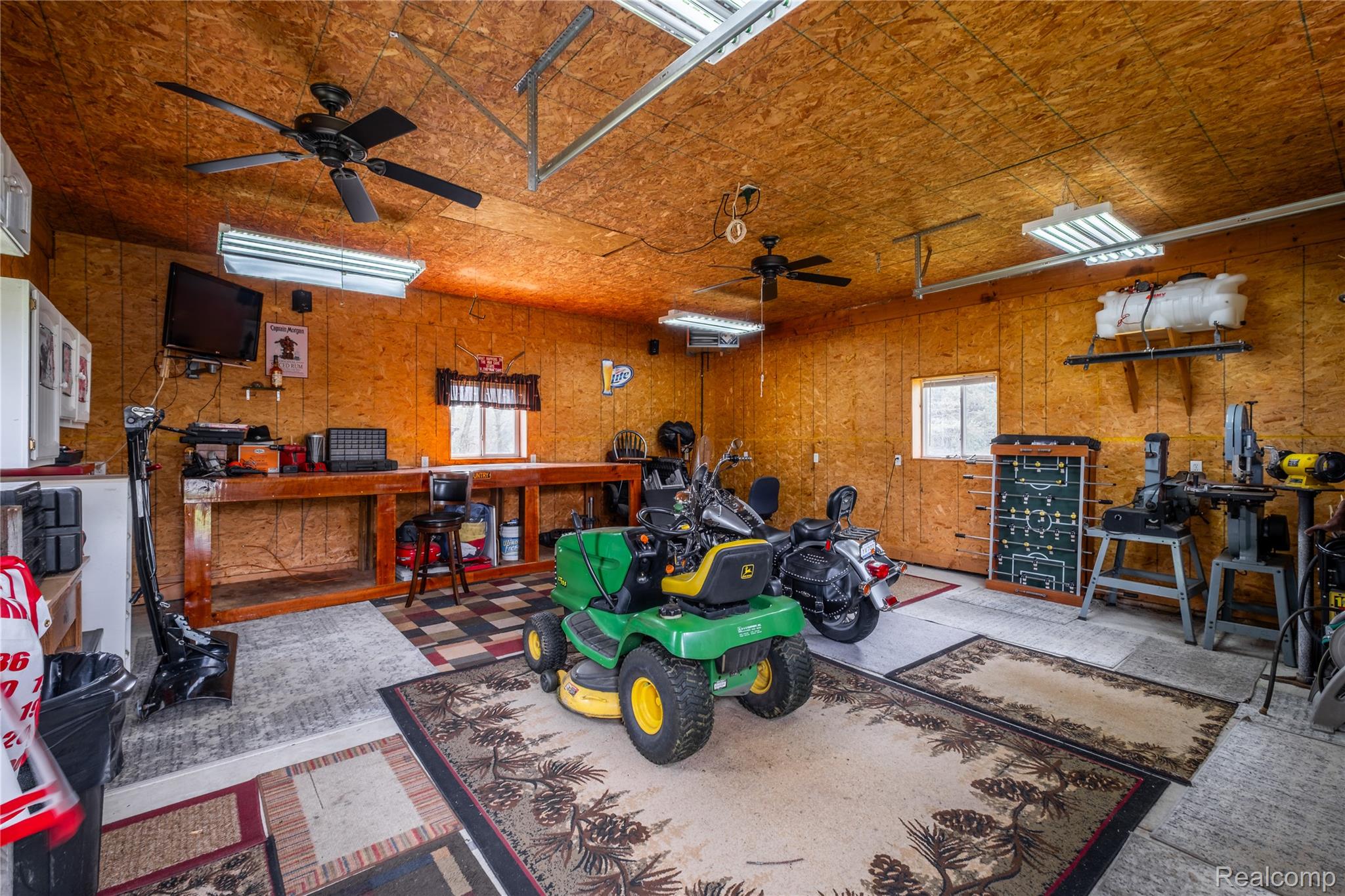 11430 Silver Lake Road Byron, MI 48418 - Photo 23 of 32 Garage featuring a ceiling fan and a workshop area