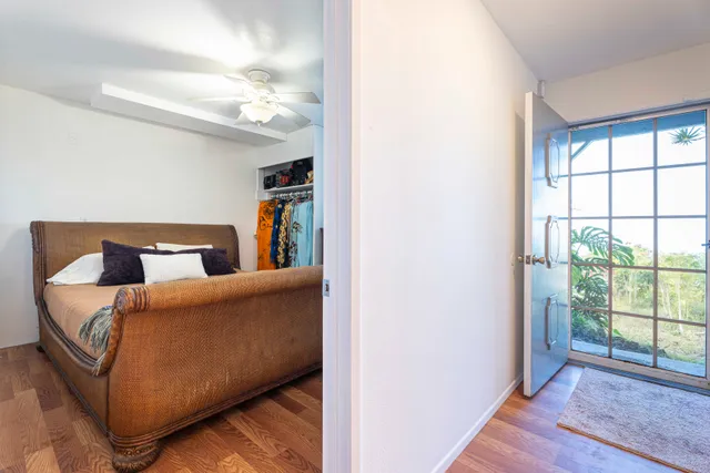 a bedroom with a large bed and a dresser