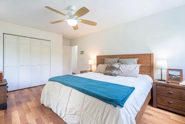 a bedroom with a large bed and a chandelier