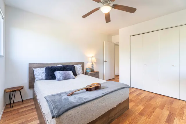 a bathroom with a granite countertop toilet sink and mirror