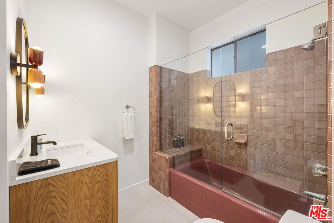 1414 Sagebrush Road Palm Springs, CA 92264 - Photo 37 of 48 a bathroom with a tub sink and mirror