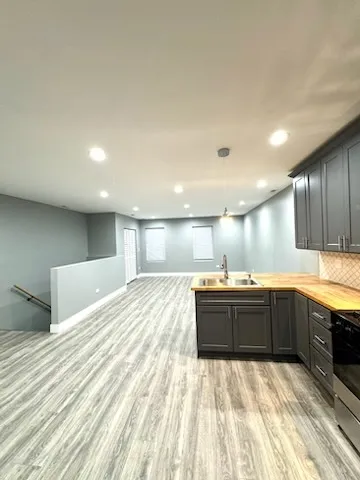 a large kitchen with kitchen island granite countertop a sink and dishwasher stove with wooden cabinets