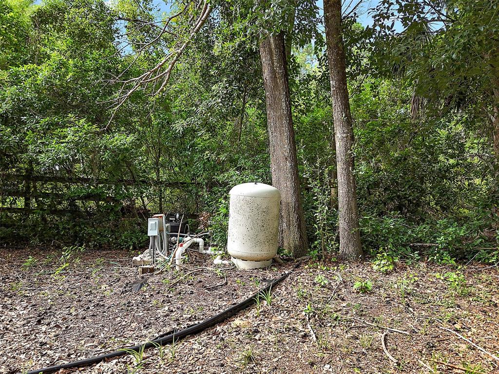 Allen St Mount Mount Dora, FL 32757 - Photo 6 of 14 a view of a backyard with table and chairs under an umbrella