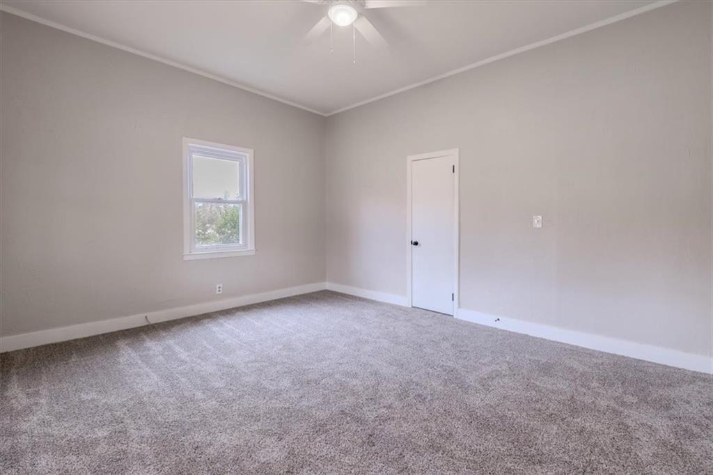 292 Ervin Coker Road Northeast Rome, GA 30161 - Photo 11 of 29 an empty room with a chandelier fan and windows