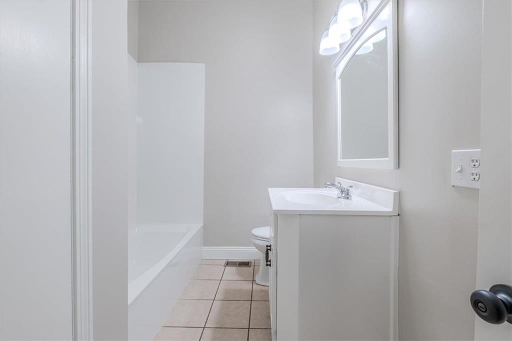 292 Ervin Coker Road Northeast Rome, GA 30161 - Photo 15 of 29 a bathroom with a sink a toilet and a mirror