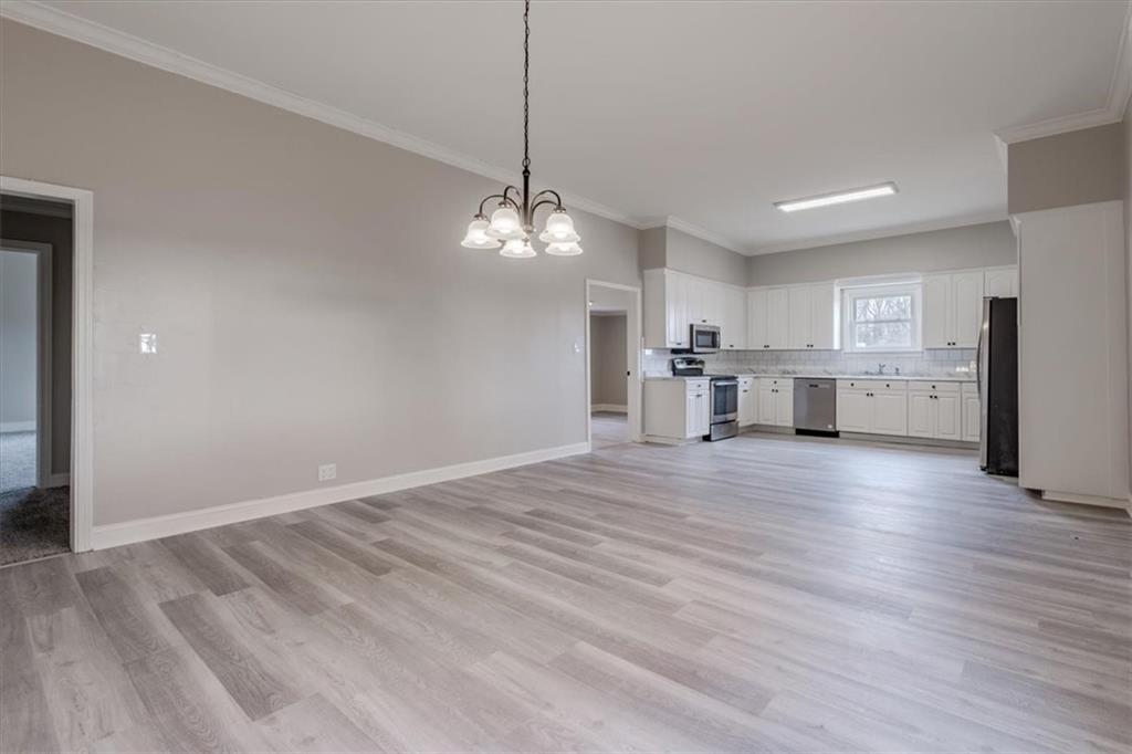 292 Ervin Coker Road Northeast Rome, GA 30161 - Photo 18 of 29 a view of a kitchen with a sink wooden cabinets and refrigerator