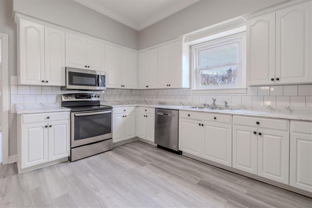 292 Ervin Coker Road Northeast Rome, GA 30161 - Photo 20 of 29 a kitchen with white cabinets stainless steel appliances and sink