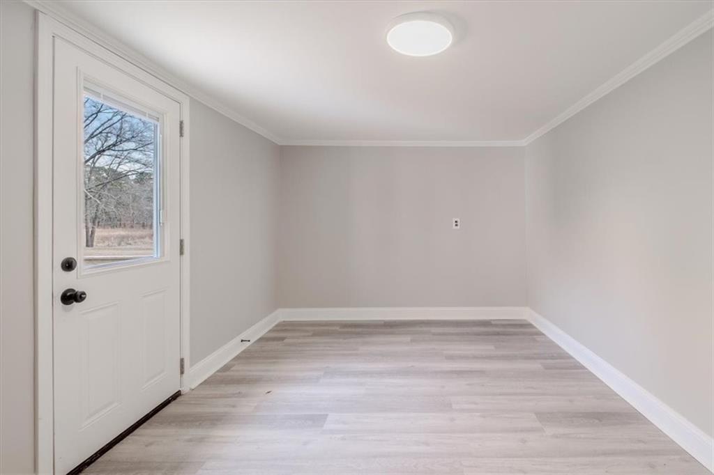 292 Ervin Coker Road Northeast Rome, GA 30161 - Photo 22 of 29 a view of an empty room with wooden floor and a window