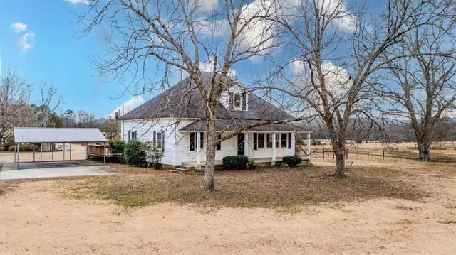 a front view of a house with a yard covered in snow