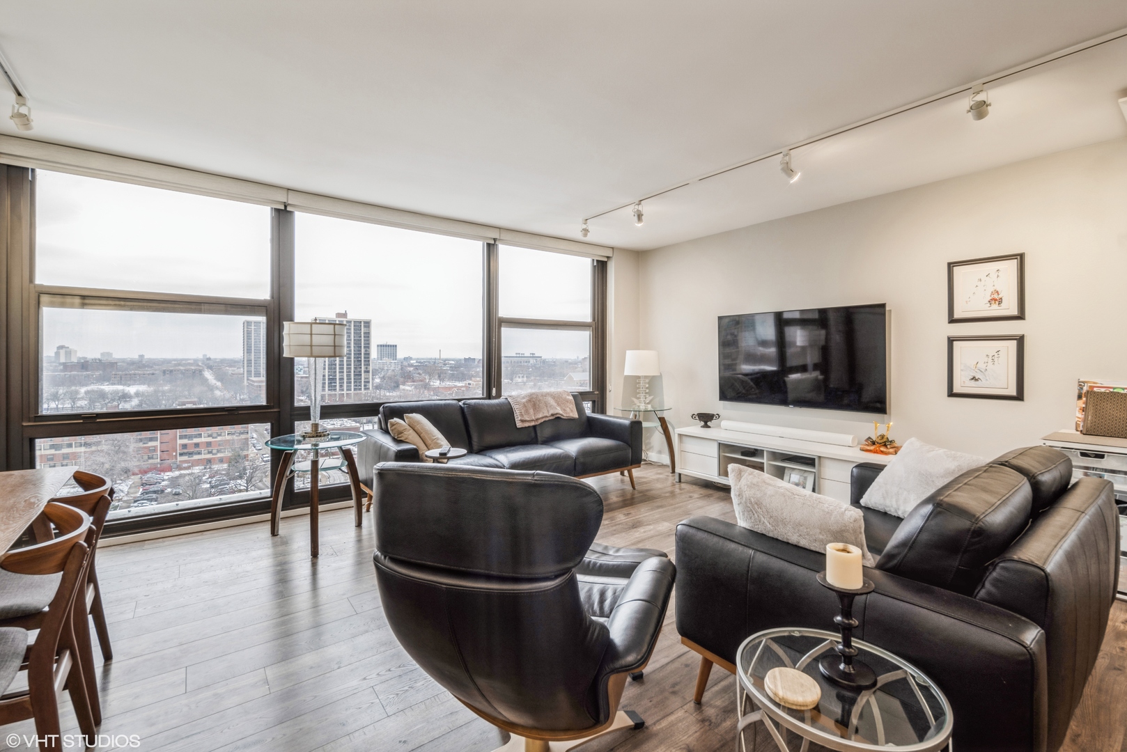 2605 South Indiana Avenue, Unit 1201 Chicago, IL 60616 - Photo 2 of 18 a living room with furniture a floor to ceiling window and a flat screen tv