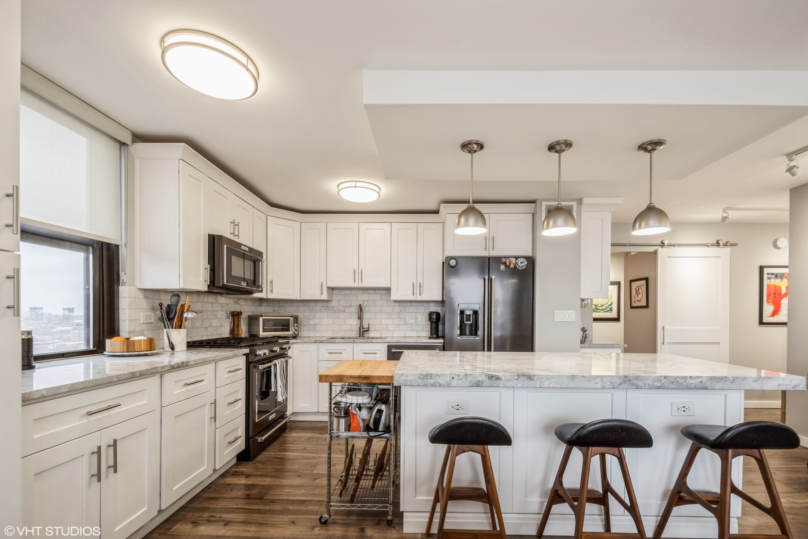 2605 South Indiana Avenue, Unit 1201 Chicago, IL 60616 - Photo 6 of 18 a kitchen with stainless steel appliances kitchen island granite countertop a sink and cabinets