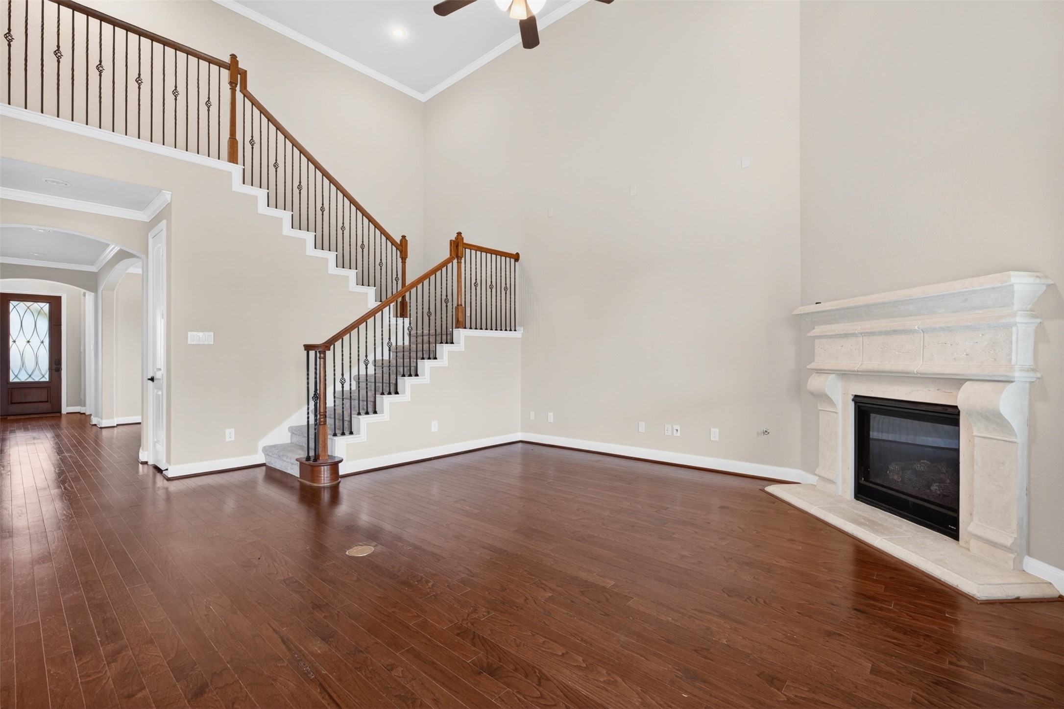 18202 Wedgewood Bluff Court Spring, TX 77379 - Photo 17 of 50 Spacious living room with high ceilings, fireplace, staircase, and open layout.