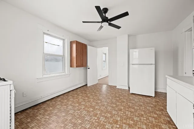 a view of empty room with wooden floor and window