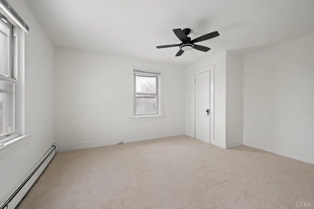 a view of a livingroom with a ceiling fan and window