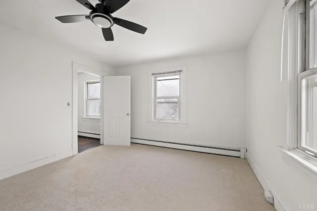 an empty room with a empty space and a ceiling fan