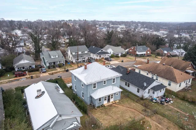 an aerial view of a house with a swimming pool and outdoor seating