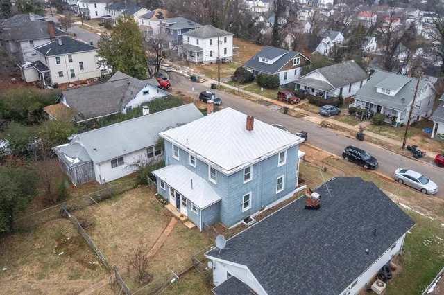 a view of a yard with wooden fence