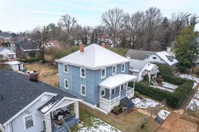 a view of a house with a table and chairs in a patio