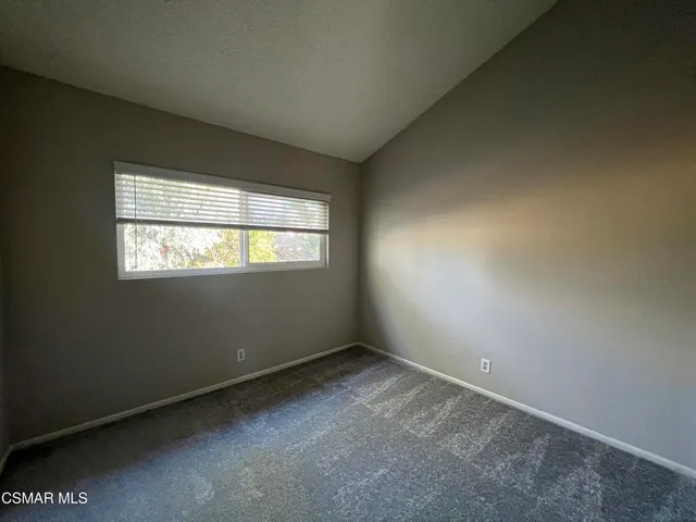 a bathroom with a granite countertop sink toilet a mirror and shower