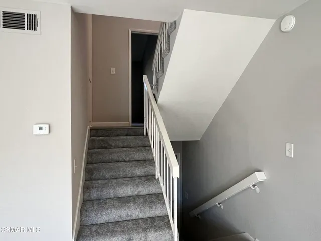 a view of swimming pool with outdoor seating and trees in the background