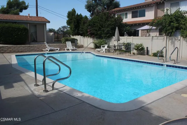a view of a street with a bench and city view