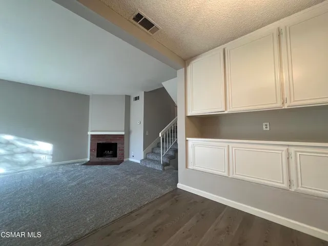 a view of kitchen with granite countertop cabinets and wooden floor