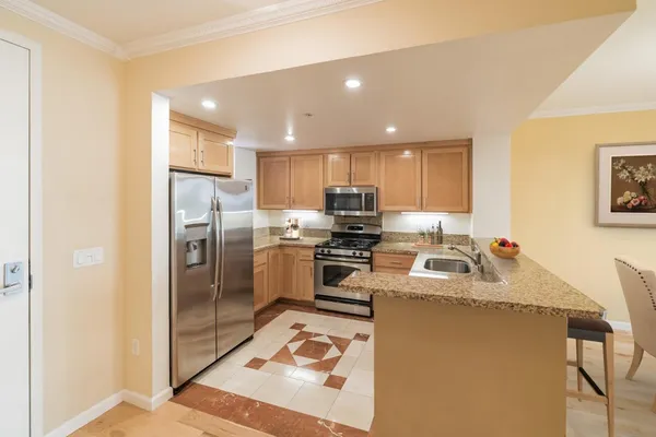 a kitchen with refrigerator a sink and cabinets