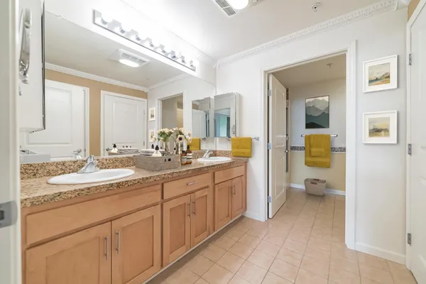 a spacious bathroom with a granite countertop sink and a mirror
