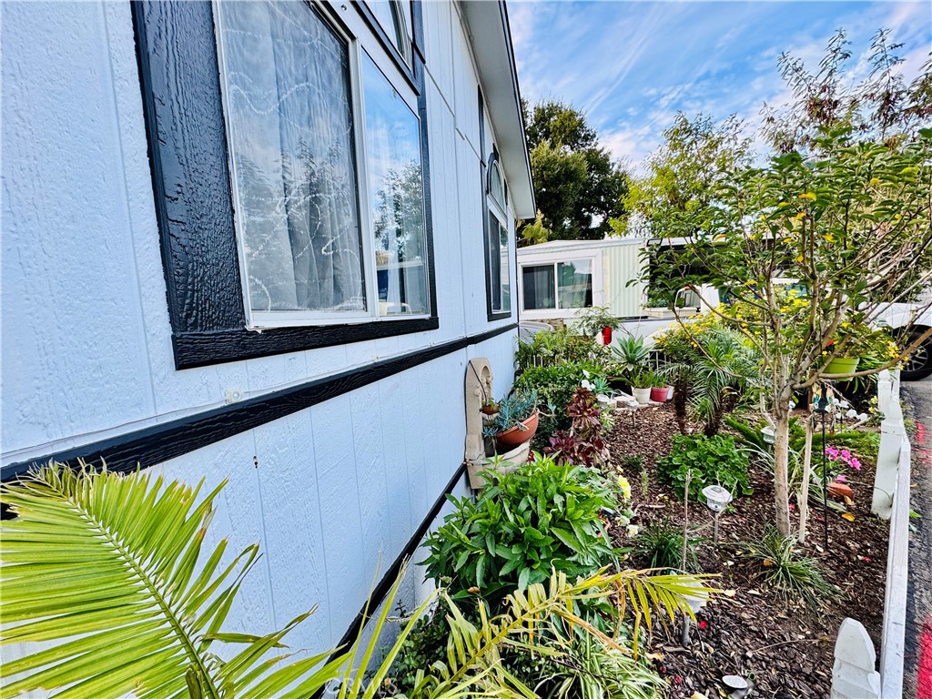 18540 Soledad Canyon Road, Unit 27 Canyon Country, CA 91351 - Photo 12 of 34 a view of a house with a flower garden