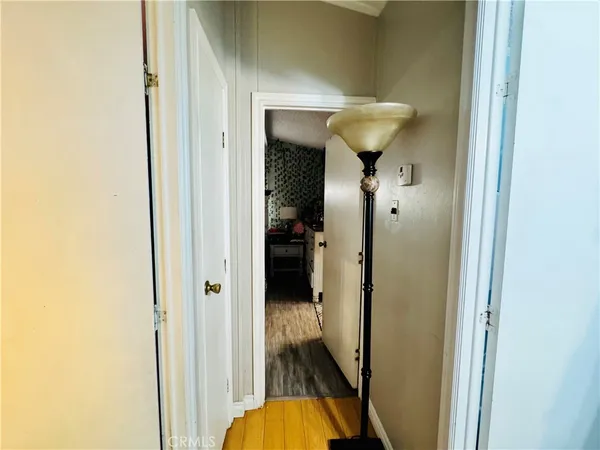 a bedroom with a bed and teddy bear on bed