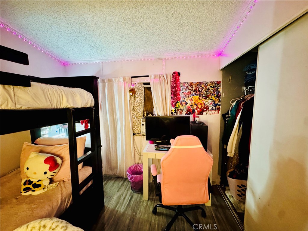 18540 Soledad Canyon Road, Unit 27 Canyon Country, CA 91351 - Photo 23 of 34 a bedroom with a bed and wooden floor