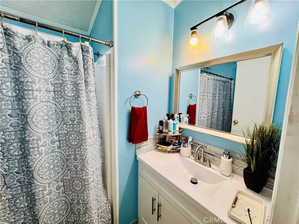 a white toilet sitting next to a shower curtain