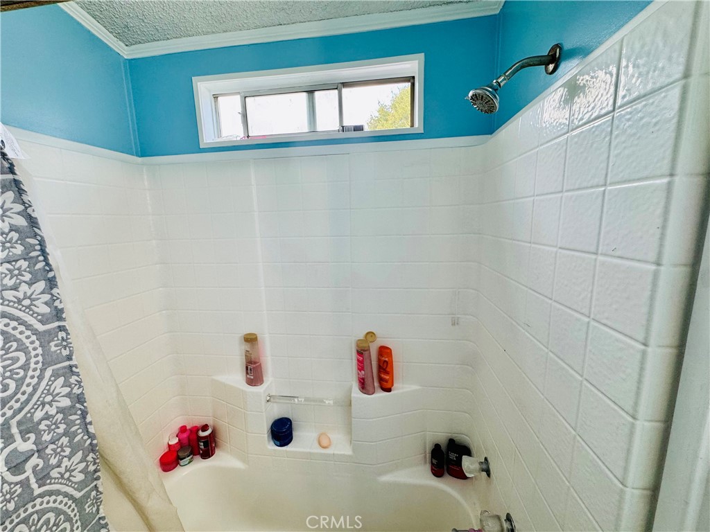 18540 Soledad Canyon Road, Unit 27 Canyon Country, CA 91351 - Photo 27 of 34 a bathroom with a bathtub and shower