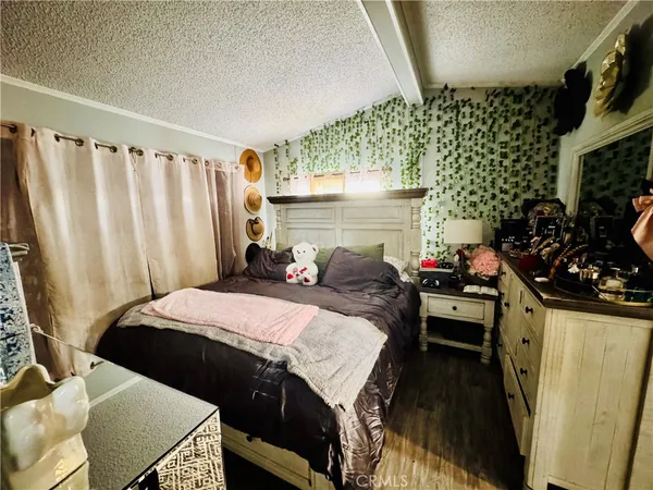 a bed room with furniture and a flat screen tv