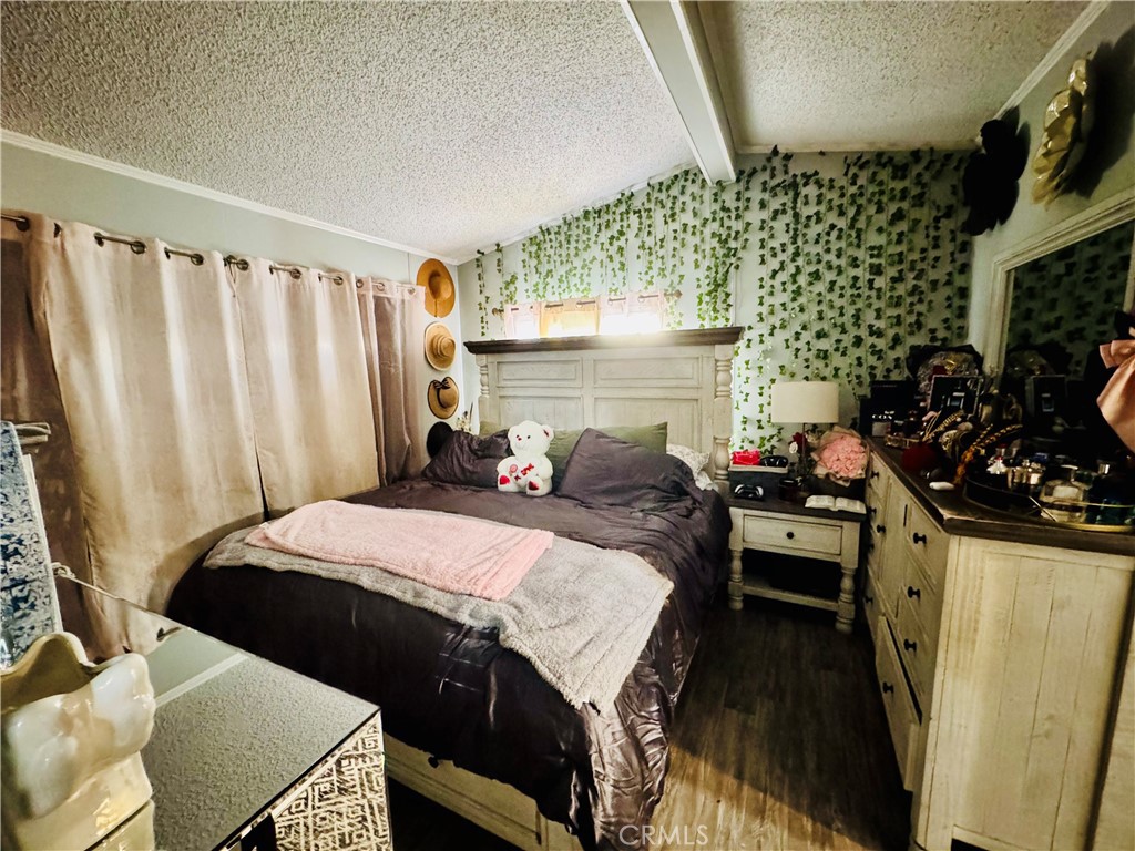 18540 Soledad Canyon Road, Unit 27 Canyon Country, CA 91351 - Photo 28 of 34 a bedroom with bed and a flat tv screen