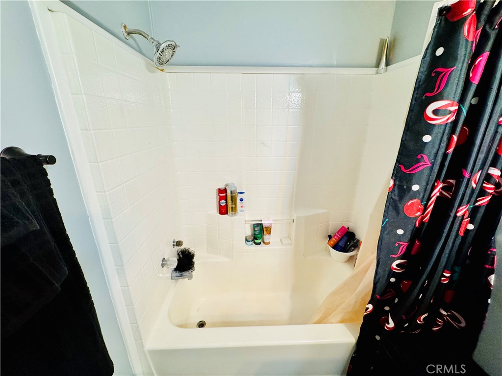 18540 Soledad Canyon Road, Unit 27 Canyon Country, CA 91351 - Photo 32 of 34 a bathroom with a bathtub and a shower