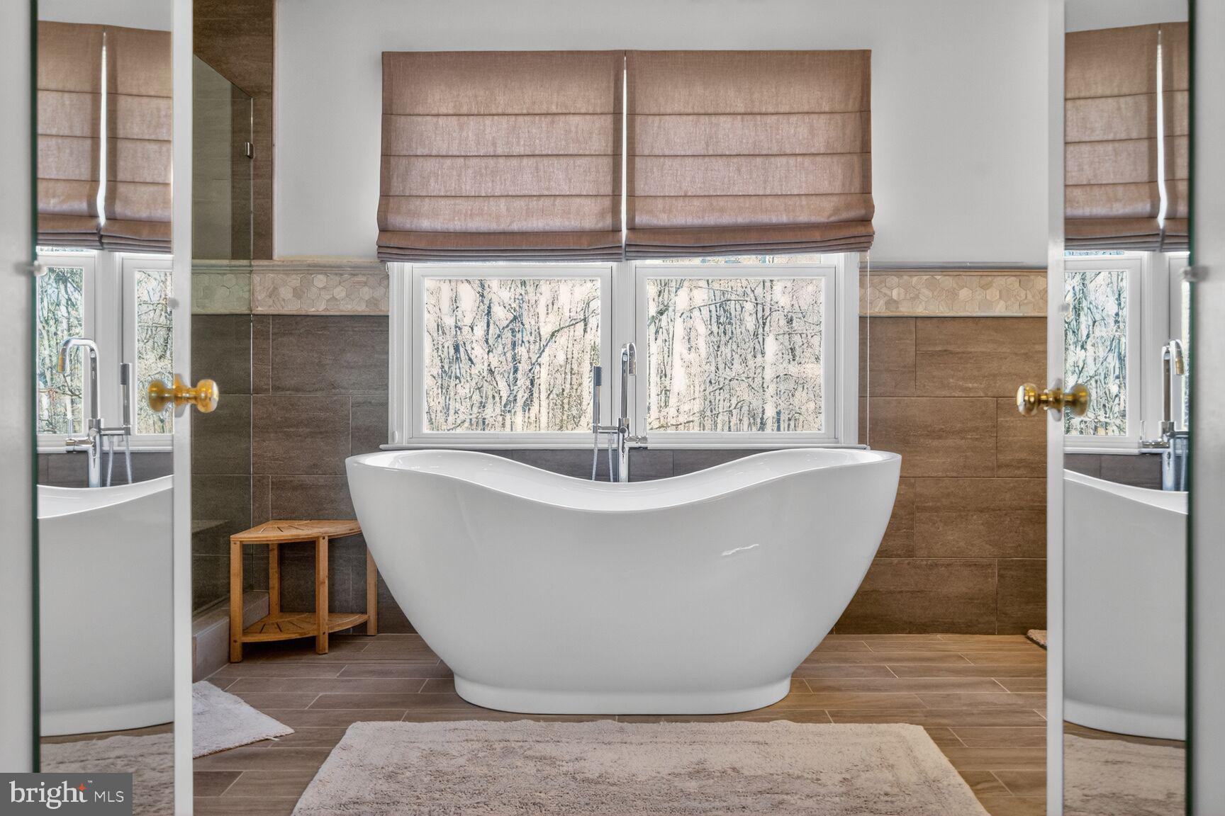 2036 Mayflower Drive Silver Spring, MD 20905 - Photo 26 of 48 a white bath tub sitting in a bathroom next to a window