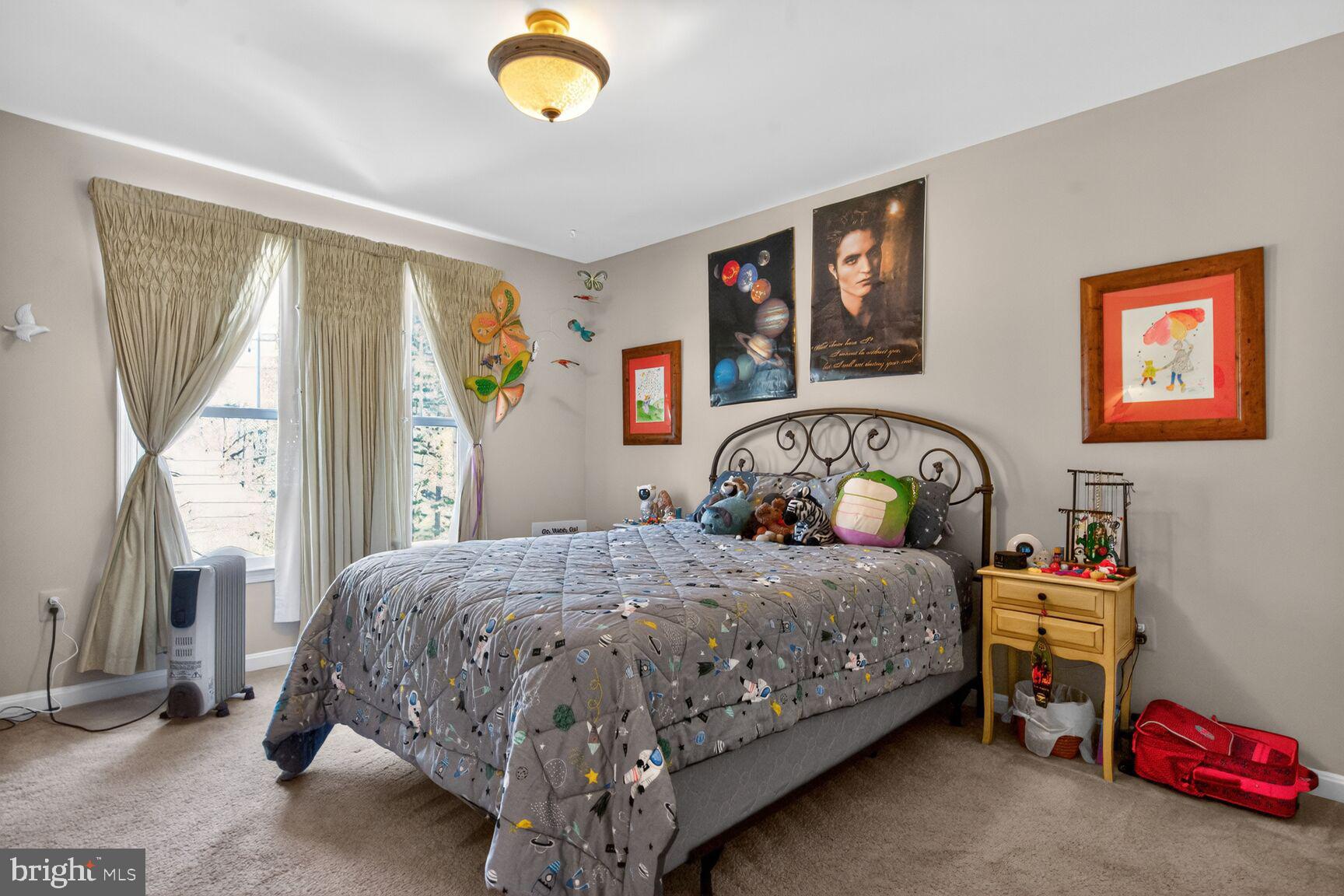 2036 Mayflower Drive Silver Spring, MD 20905 - Photo 31 of 48 a bedroom with a bed and a chandelier