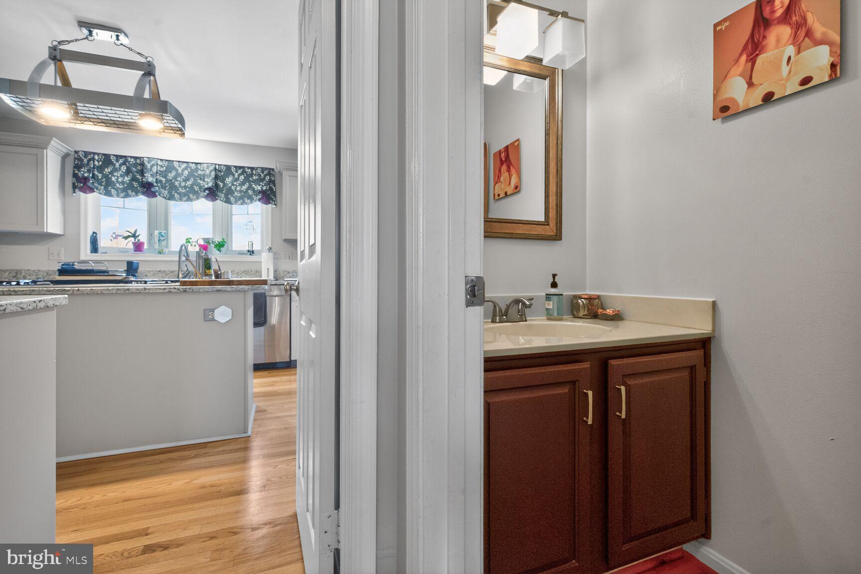 2036 Mayflower Drive Silver Spring, MD 20905 - Photo 35 of 48 a kitchen with a sink cabinets and wooden floor