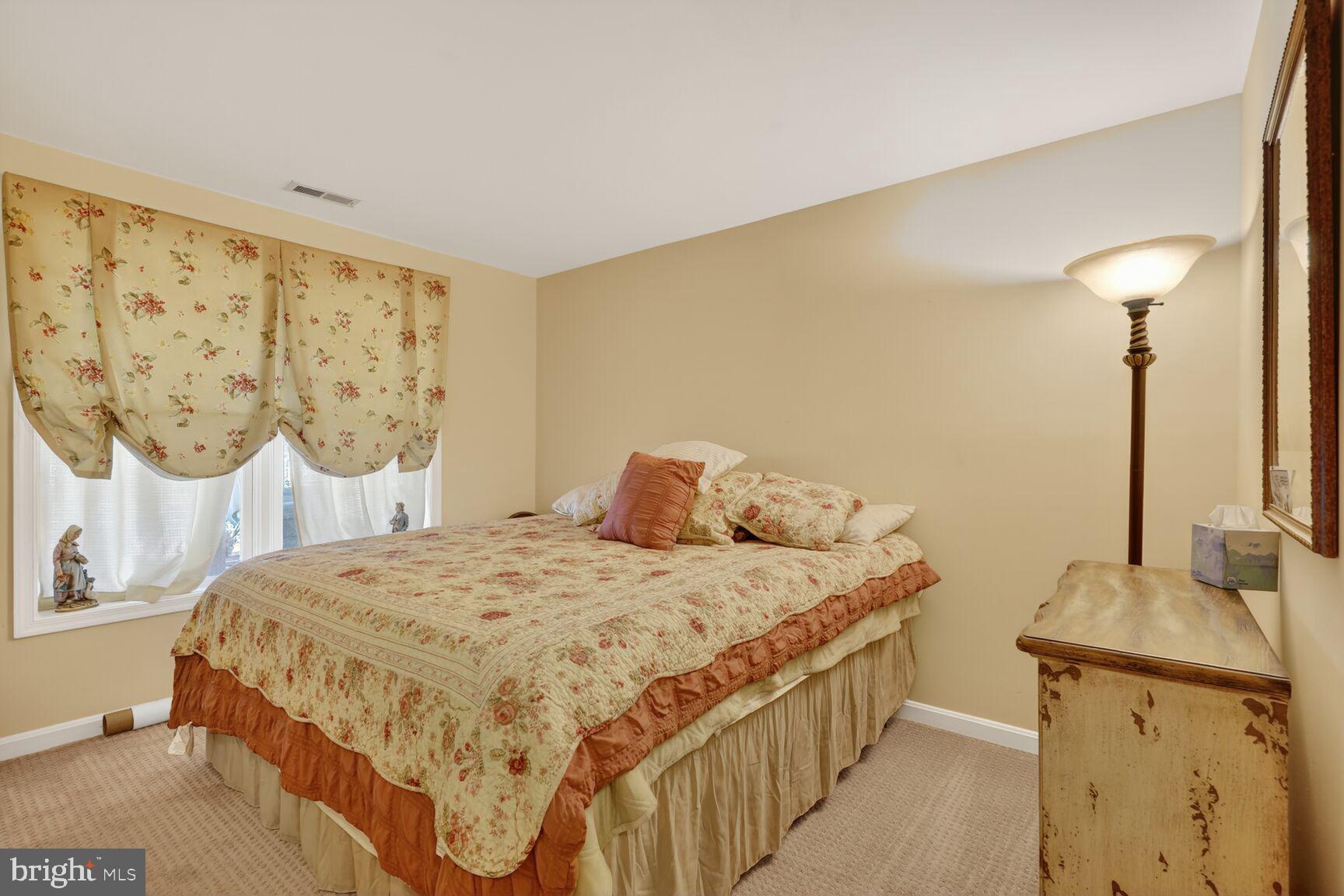 2036 Mayflower Drive Silver Spring, MD 20905 - Photo 39 of 48 a bedroom with a bed and a dresser next to a window