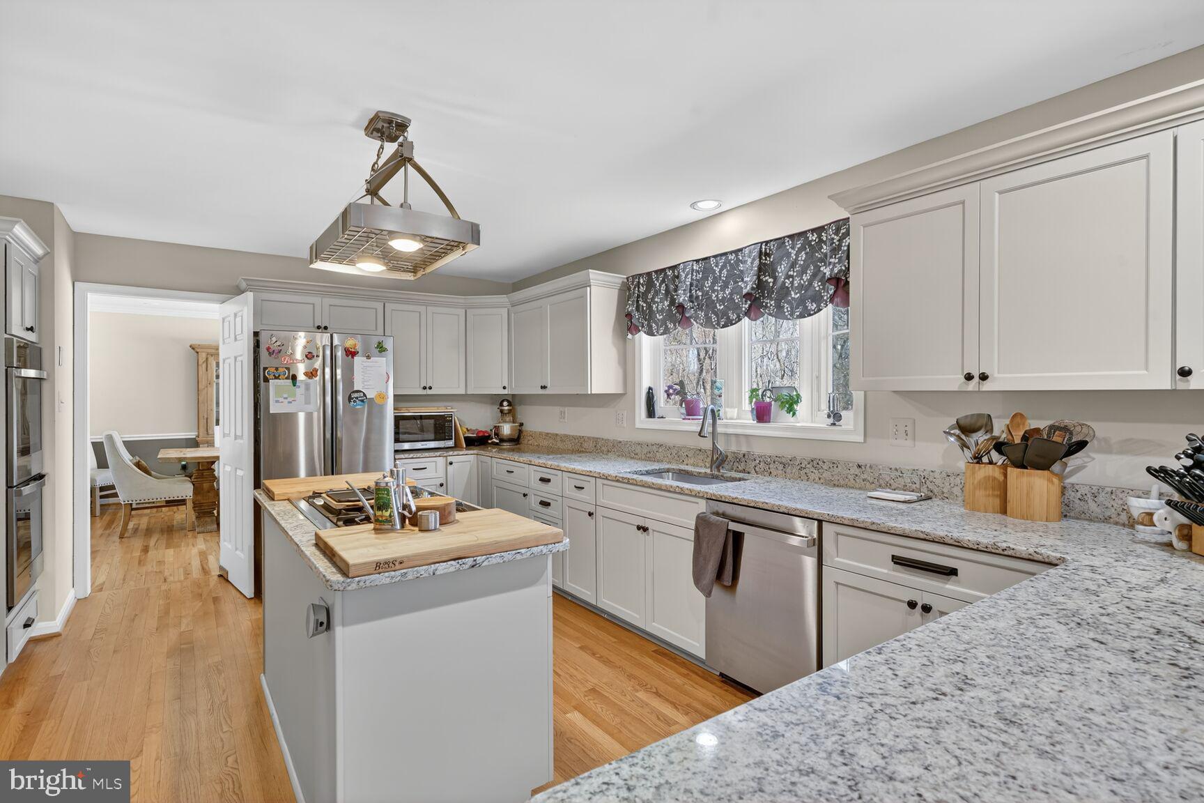 2036 Mayflower Drive Silver Spring, MD 20905 - Photo 6 of 48 a kitchen that has a lot of cabinets in it and wooden floors