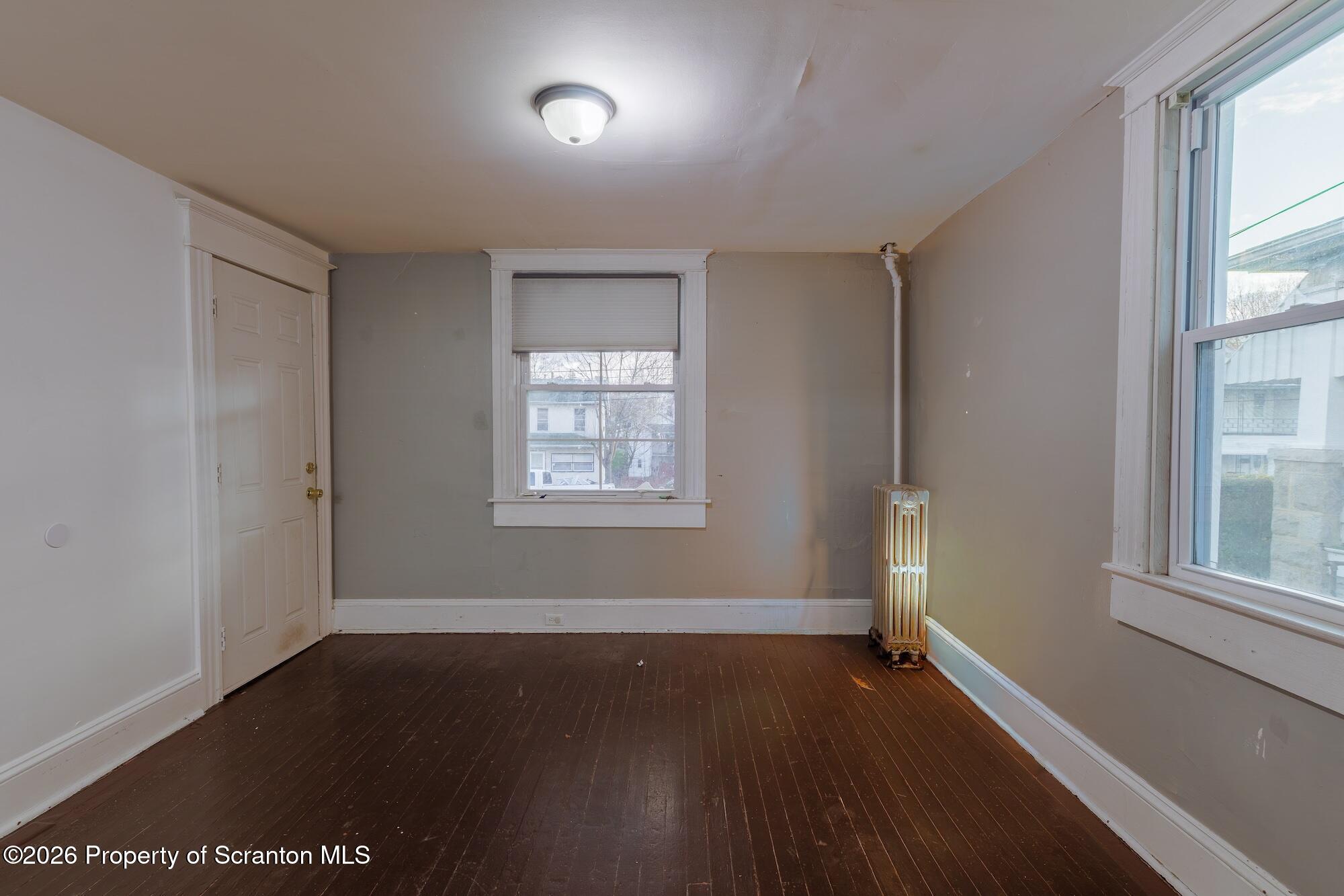 623 East Elm Street, Unit 1 Scranton, PA 18505 - Photo 4 of 15 an empty room with wooden floor and windows