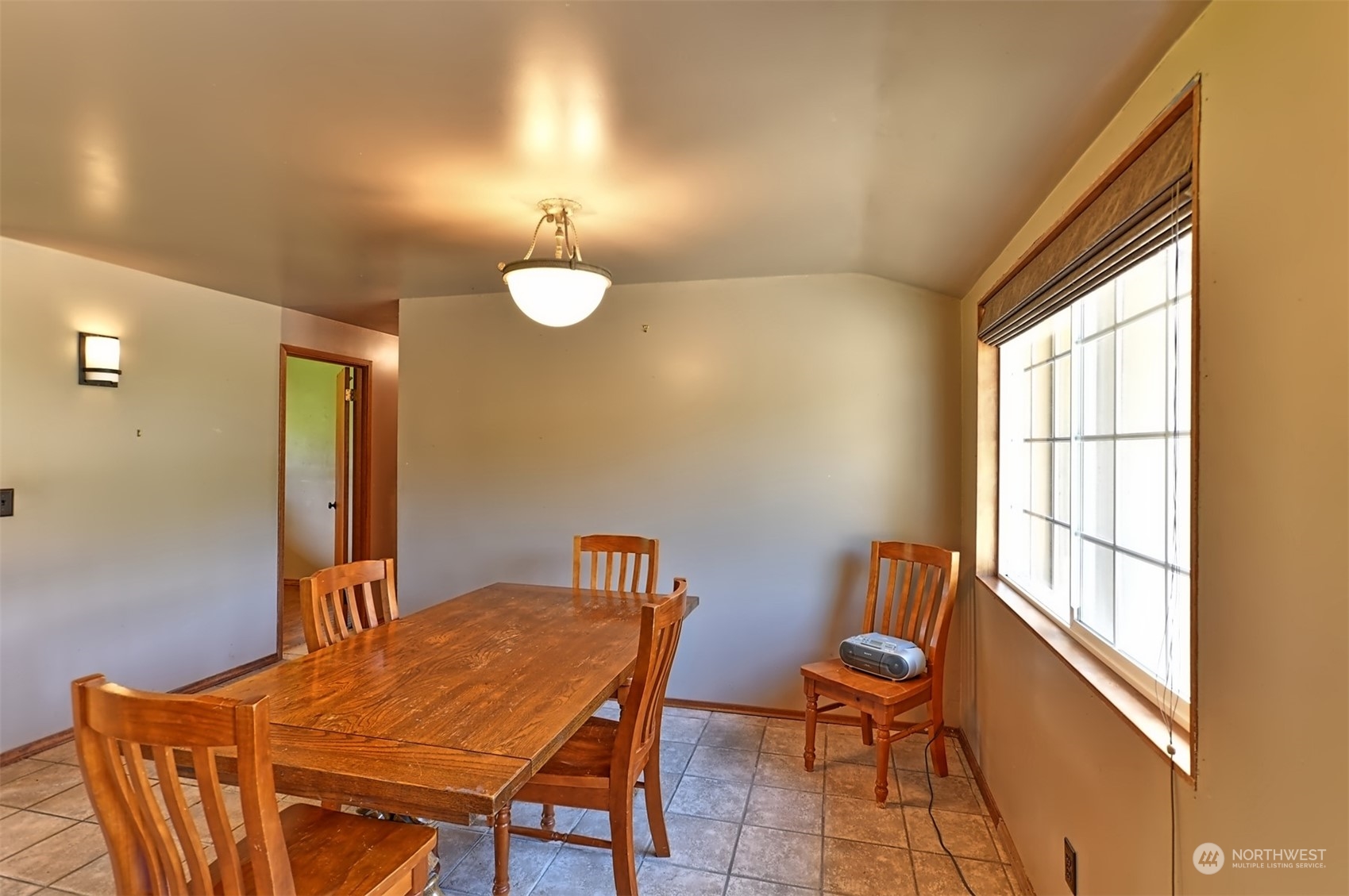 23720 Locust Way Bothell, WA 98021 - Photo 18 of 30 a view of a dining room with furniture and a window