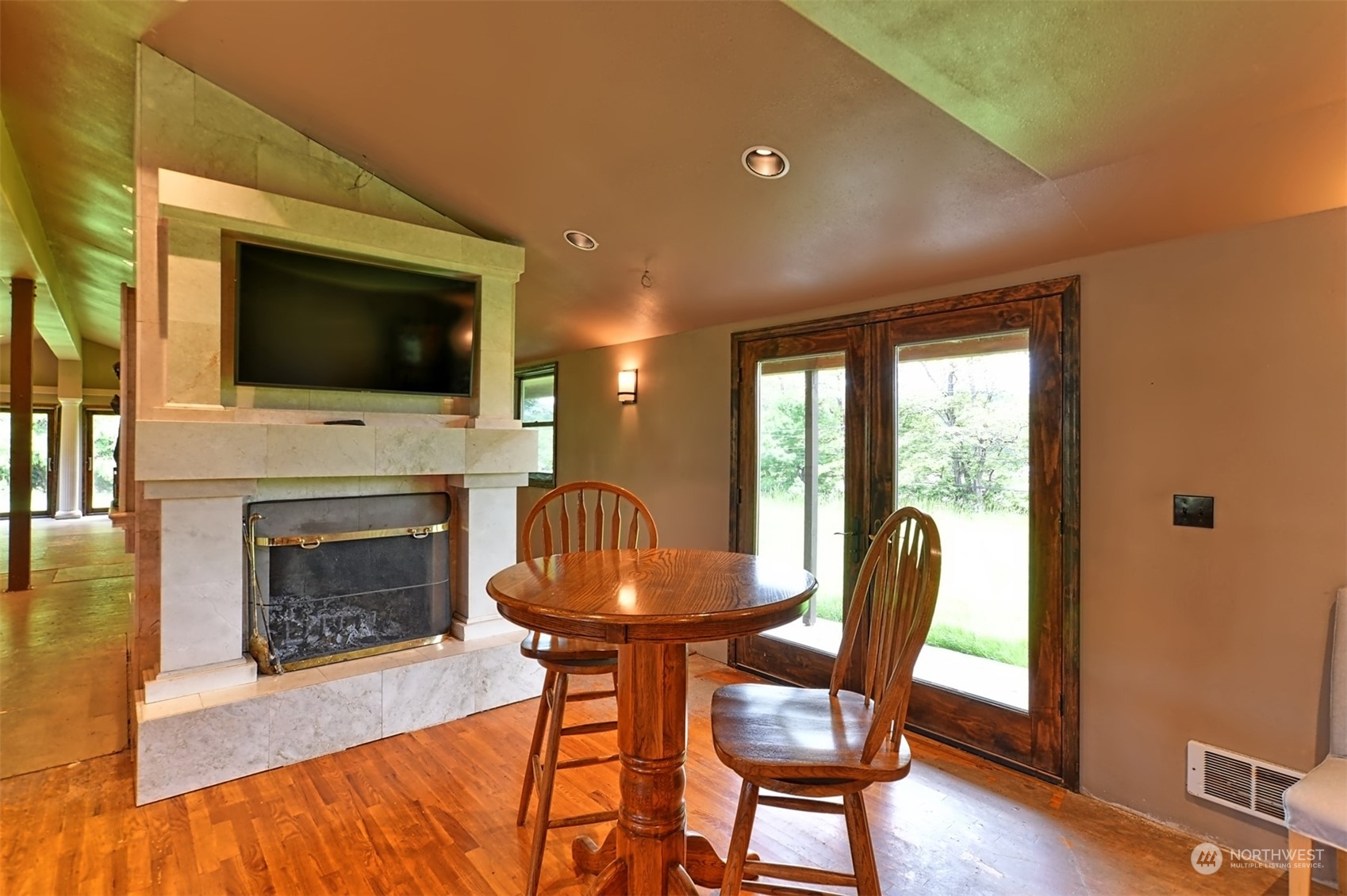 23720 Locust Way Bothell, WA 98021 - Photo 8 of 30 a living room with furniture a flat screen tv and a fireplace