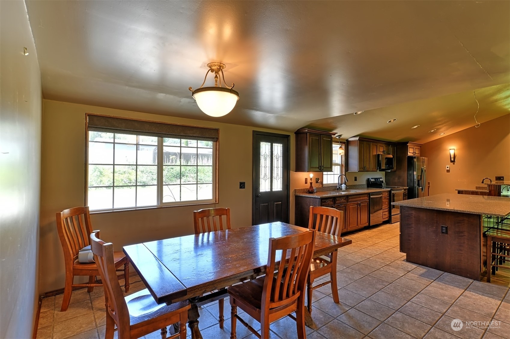 23720 Locust Way Bothell, WA 98021 - Photo 9 of 30 a view of a dining room with furniture and a kitchen