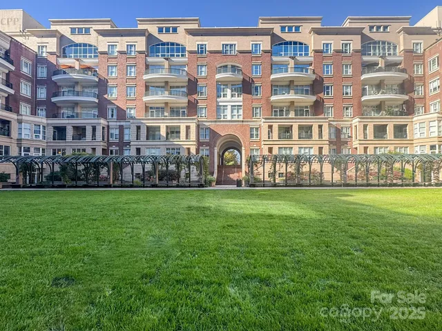 a front view of a building with a garden