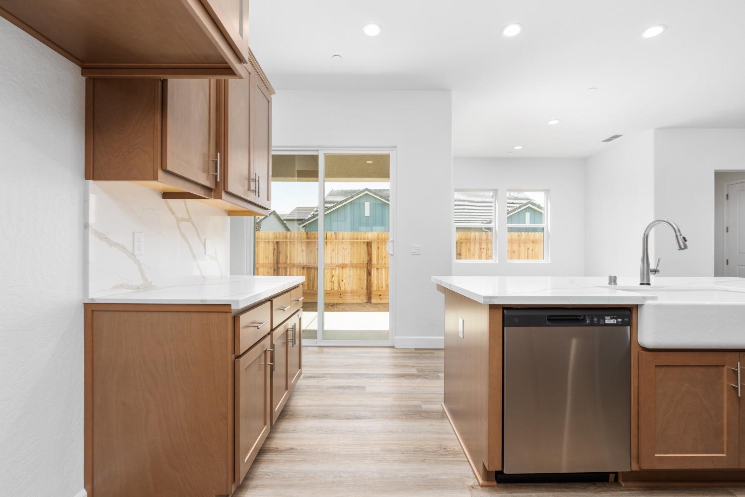 276 Huckleberry Lane South Madera, CA 93636 - Photo 12 of 32 a kitchen with stainless steel appliances granite countertop a sink and a wooden cabinets