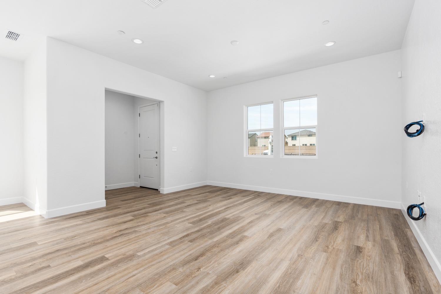 276 Huckleberry Lane South Madera, CA 93636 - Photo 16 of 32 an empty room with wooden floor and windows