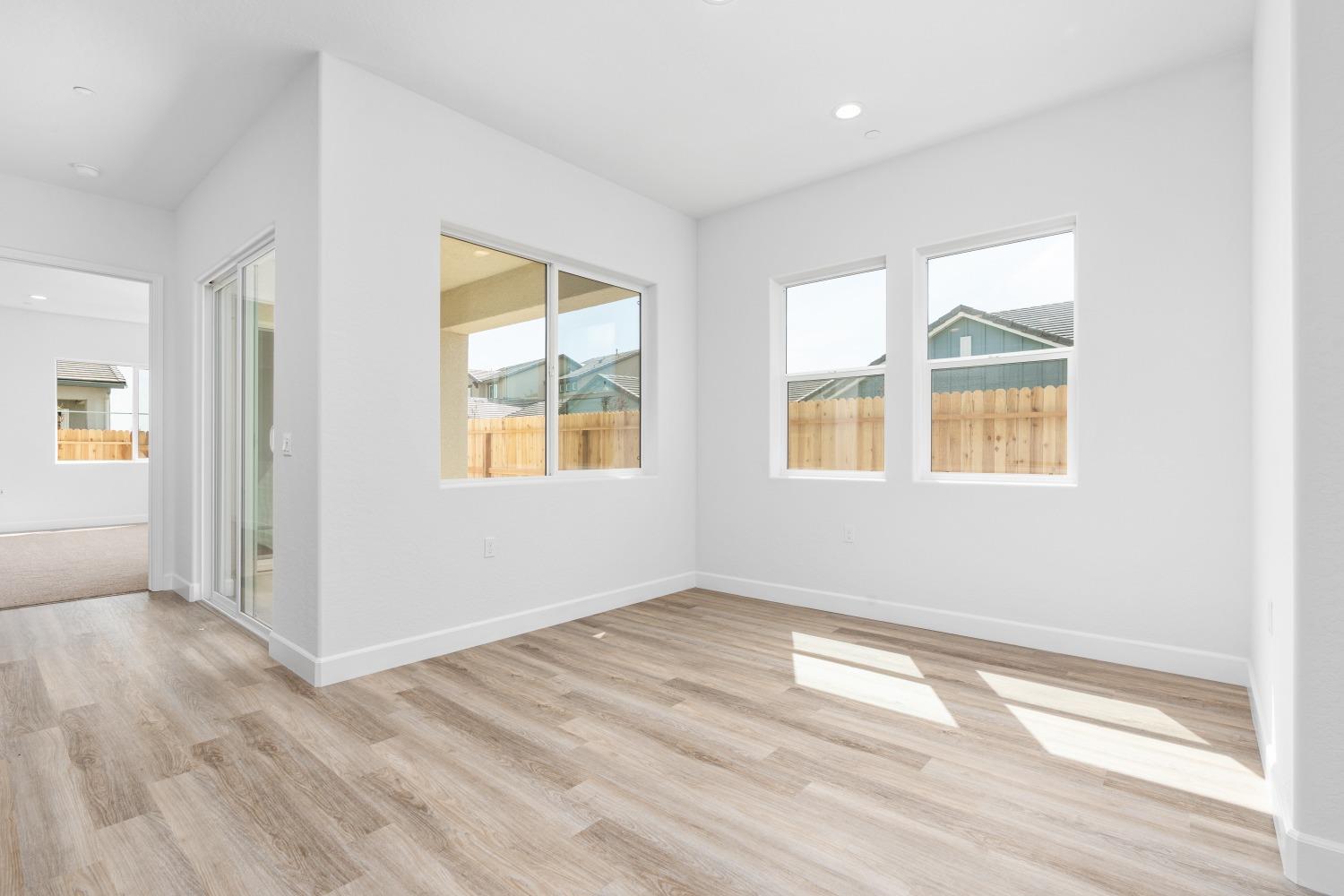 276 Huckleberry Lane South Madera, CA 93636 - Photo 17 of 32 a view of an empty room with wooden floor and a window